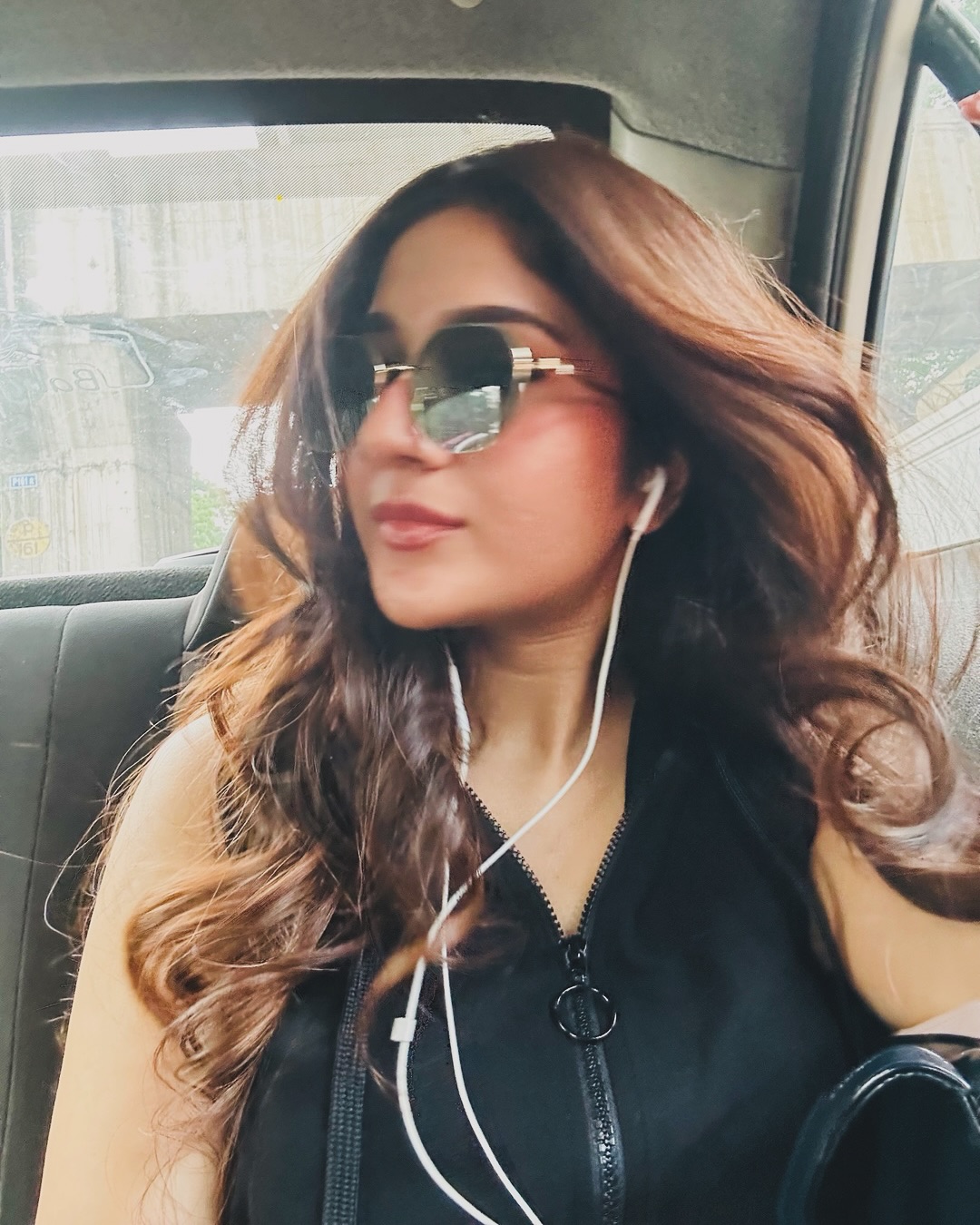 Rabiya Khatoon rocking oversized curls, a sleek black vest, and stylish sunglasses–proof that even on the go, she’s too fabulous to ignore!