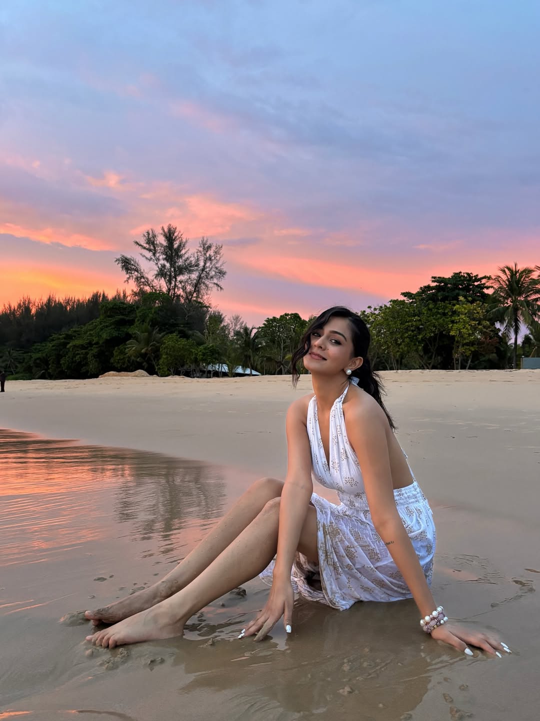 Rutvi Tiwari proving that even the sunset can't compete with her glow–white dress, beach breeze, and a style that’s pure ocean magic!