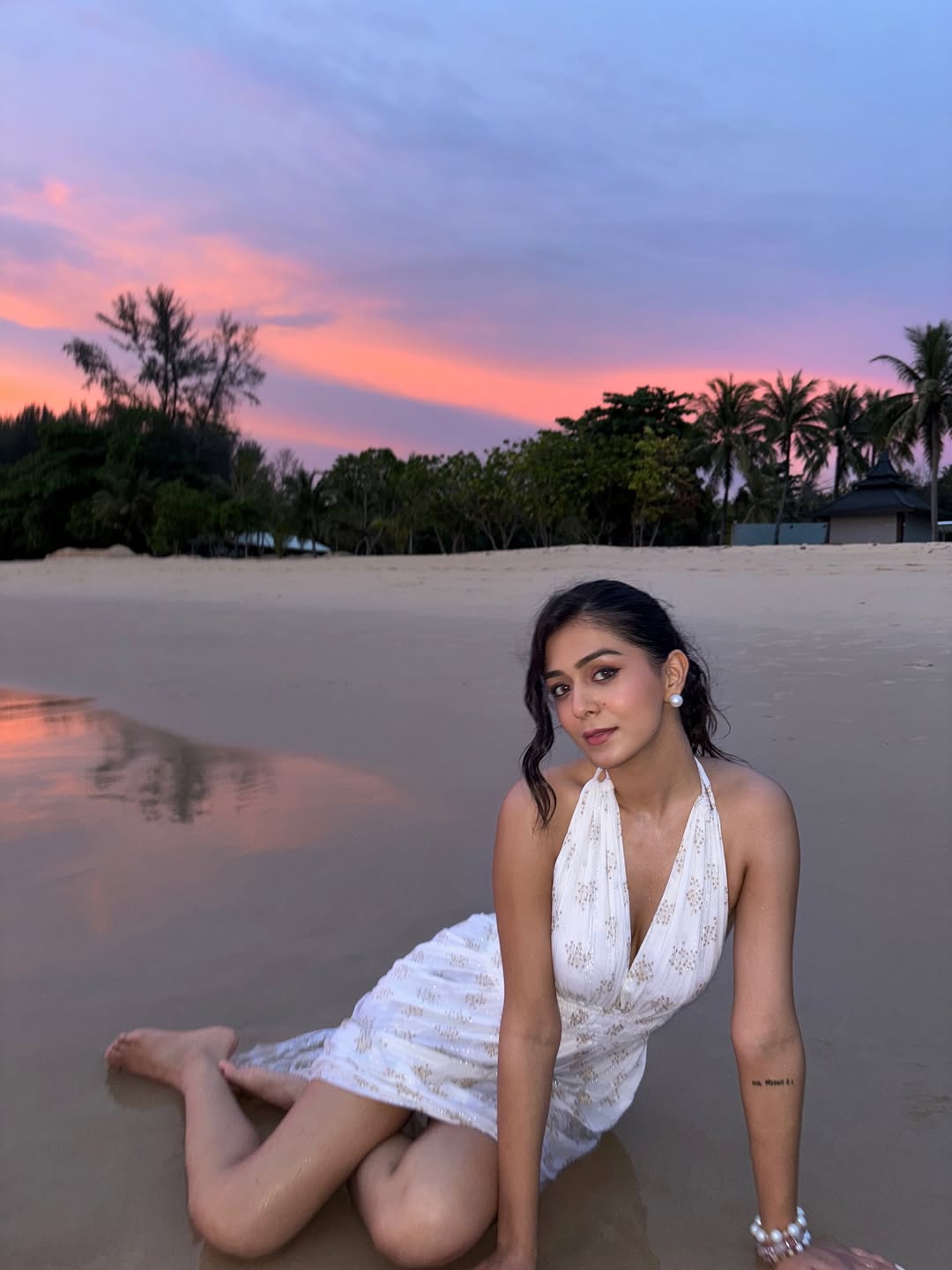 Rutvi Tiwari proving that even a sunset can't compete with her glow–dressed in white, rocking those beachy waves, and making the shoreline her personal runway!