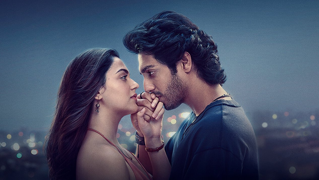 A romantic still where Ahaan Panday kisses Aneet Padda’s hand, capturing their emotional bond.