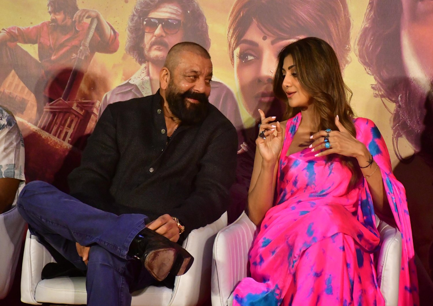 Sanjay Dutt and Shilpa Shetty engage in a candid exchange amidst the media photoshoot.