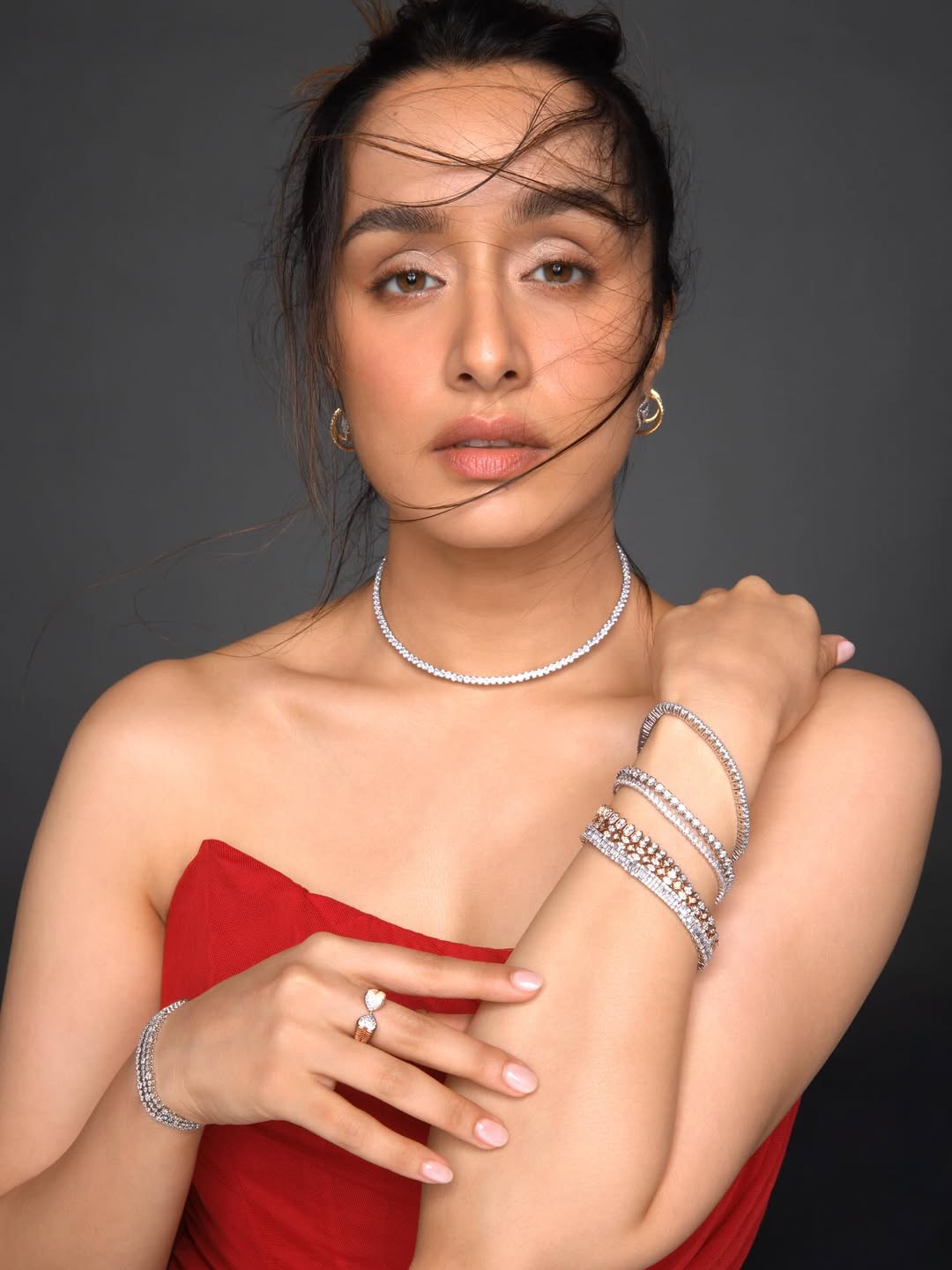 Shraddha Kapoor exudes timeless elegance in a striking red ensemble, perfectly complemented by her sparkling jewelry–proof that even wind-blown hair and a confident gaze can steal the spotlight with style and a dash of glamorous humor.