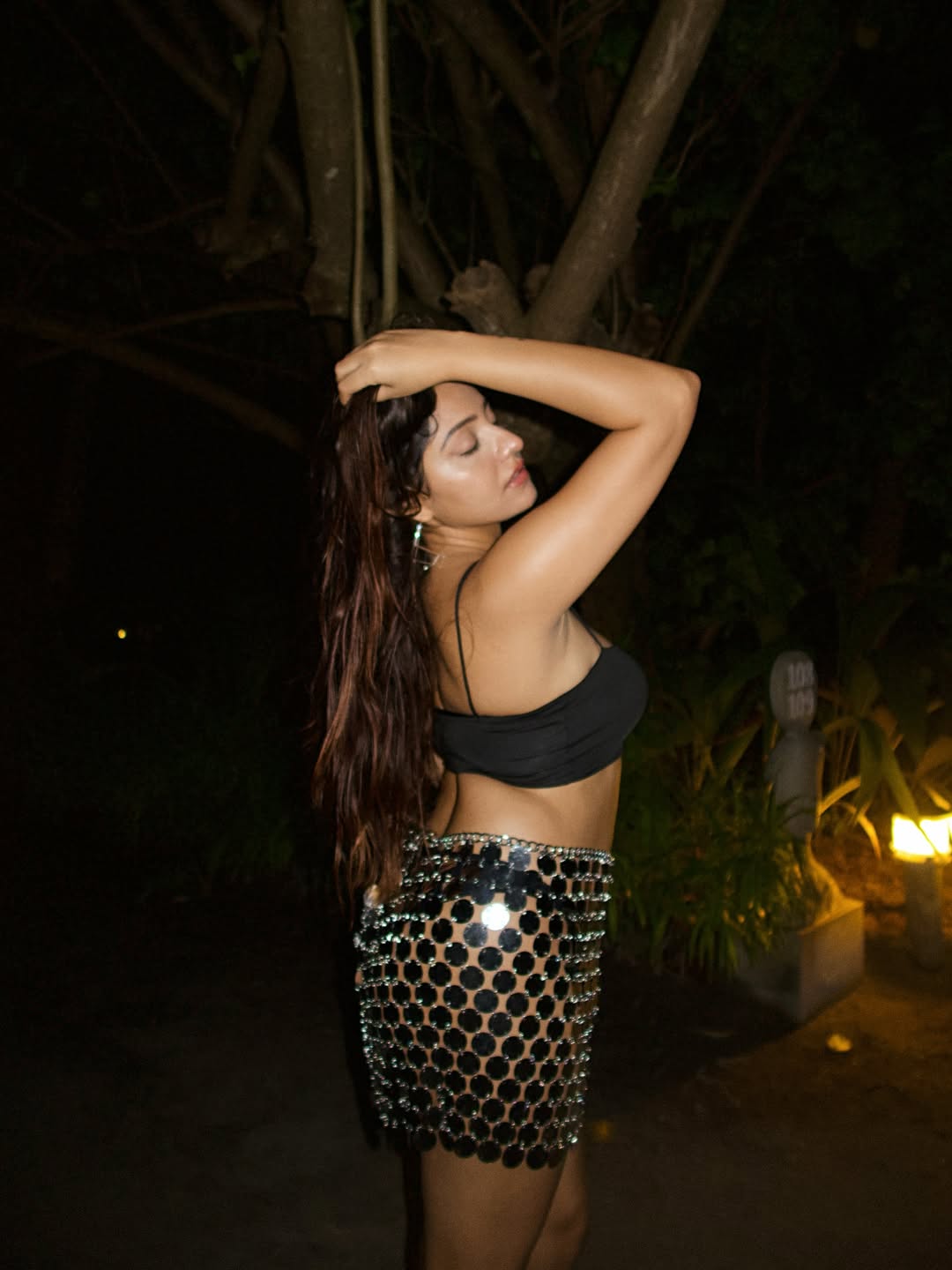 Simran Kaur proves that even in the dark, her style shines brighter than the stars–rocking a daring black crop top and a sparkling mirror skirt with effortless grace and a touch of night-time glamour!