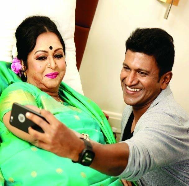 B. Saroja Devi and Puneeth Rajkumar sharing a cheerful selfie moment.