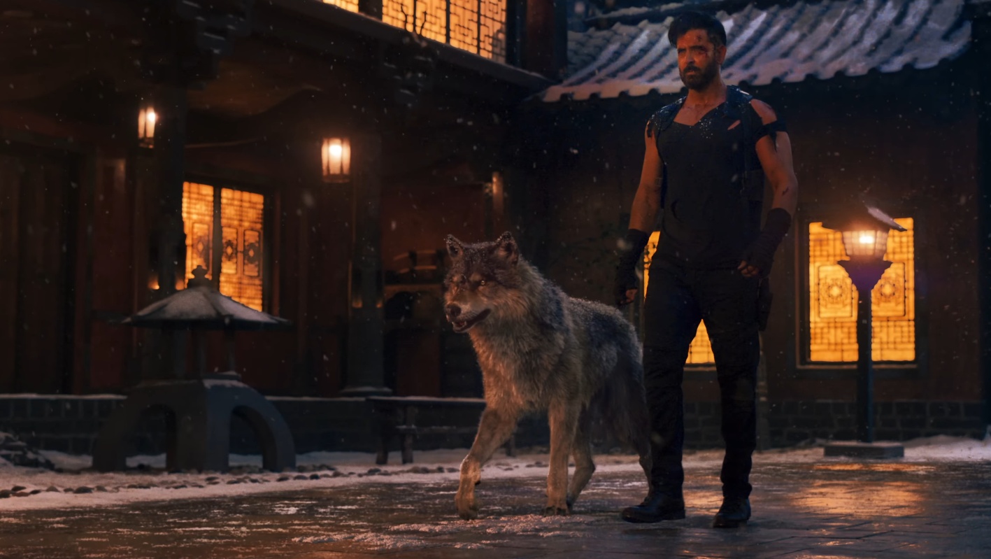 Hrithik Roshan captured in a commanding walk with his dog, exuding raw intensity in this cinematic frame.