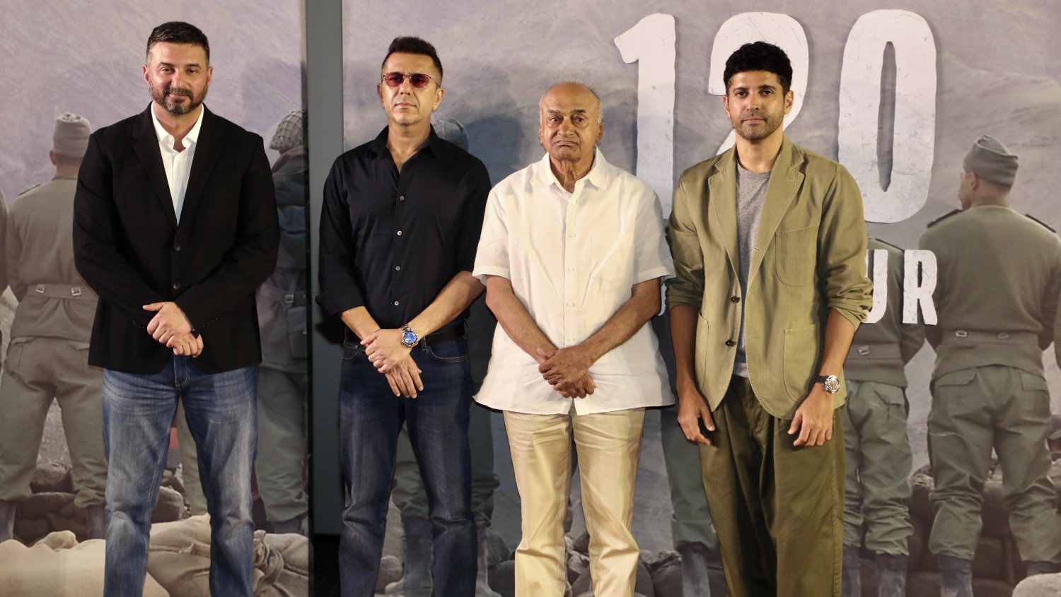Director Razneesh Ghai, producer Ritesh Sidhwani, and actor Farhan Akhtar pose together for the media during the teaser launch.