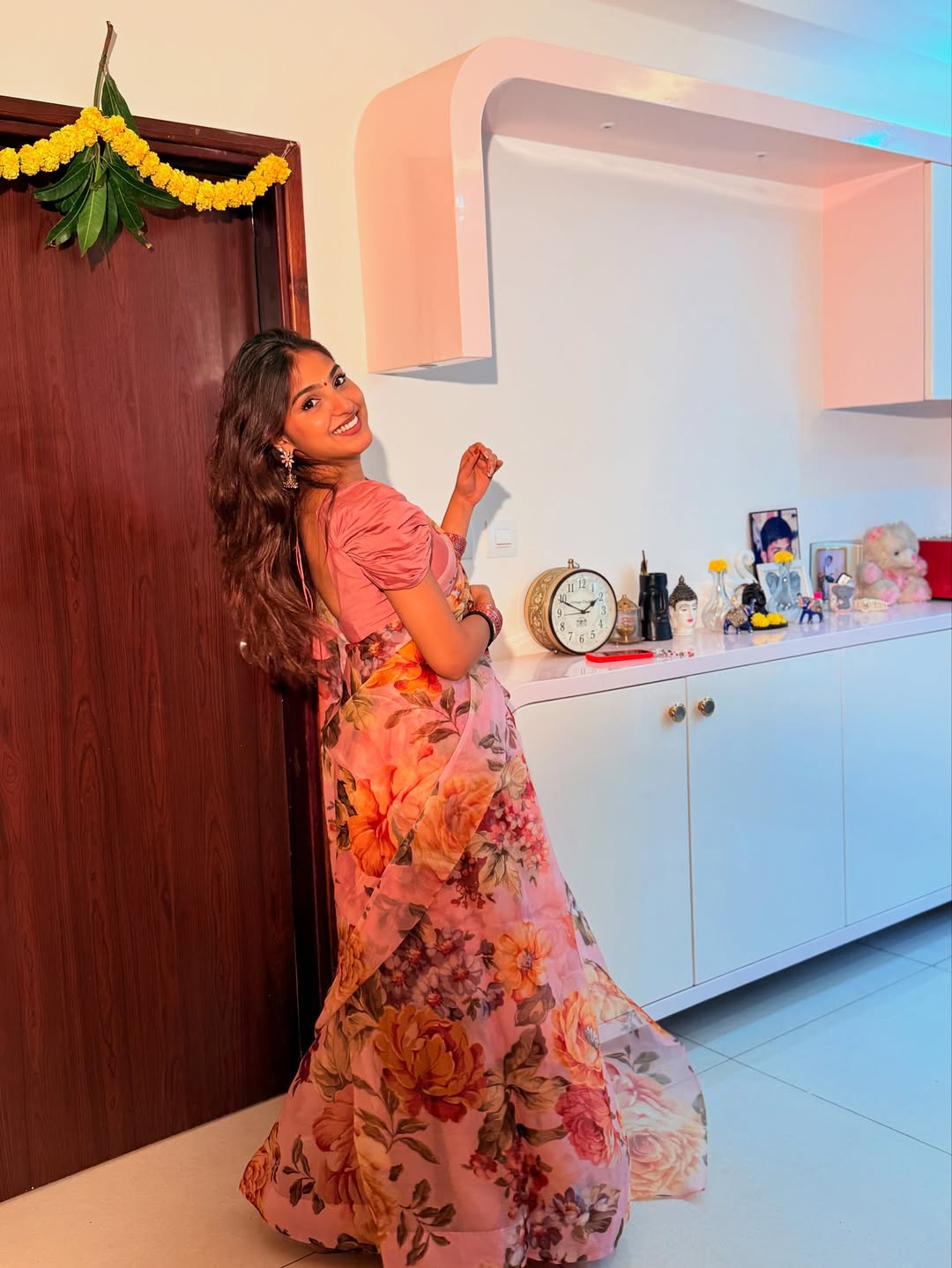 Pranavi Manukonda in floral dress posing confidently