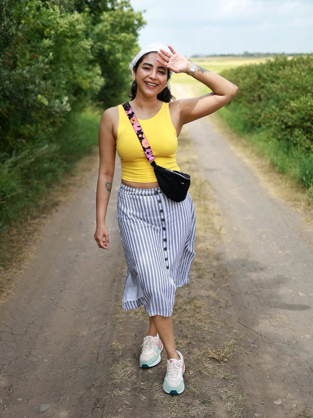Ameya Mathew rocks a vibrant yellow tank top paired with a breezy striped skirt–proof that casual outdoor chic can be both playful and stylish, with a touch of sporty flair!