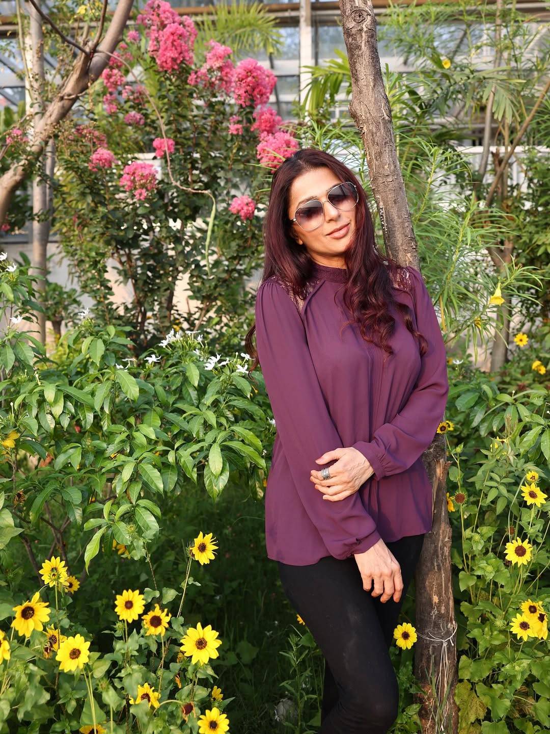 Bhumika Chawla effortlessly blends floral charm with urban elegance in her deep purple blouse and sleek black pants–because even in a garden, she’s blooming with style and a touch of humor!
