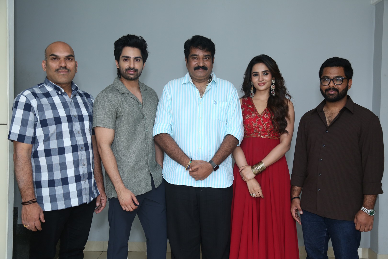 Cast and director posing together for media