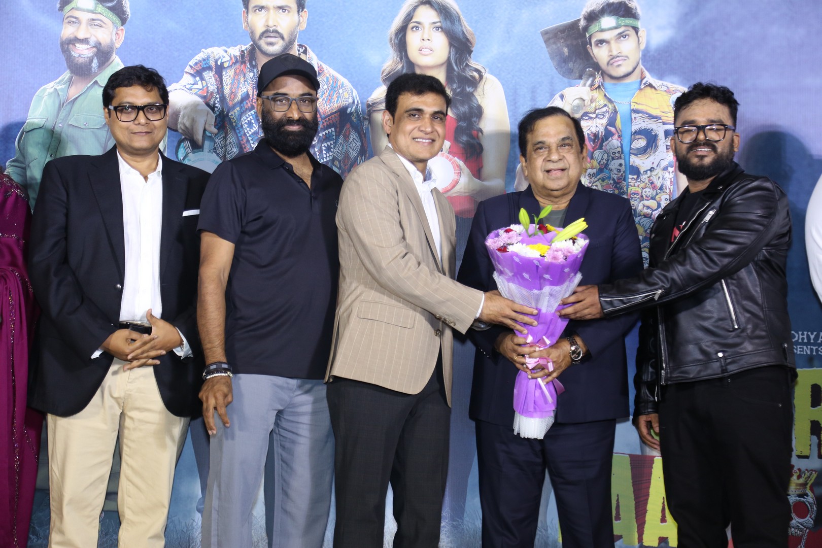 The Gurram Paapi Reddy team warmly welcomed Brahmanandam with a floral bouquet at the event.