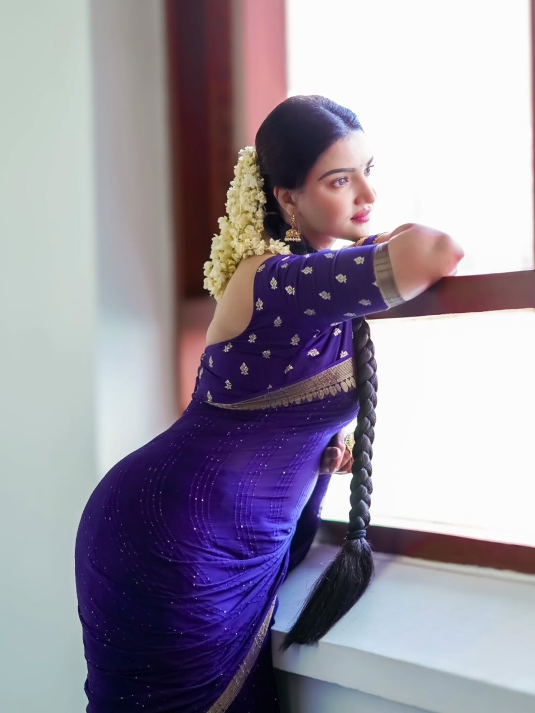 Honey Rose with jasmine braid in blue saree