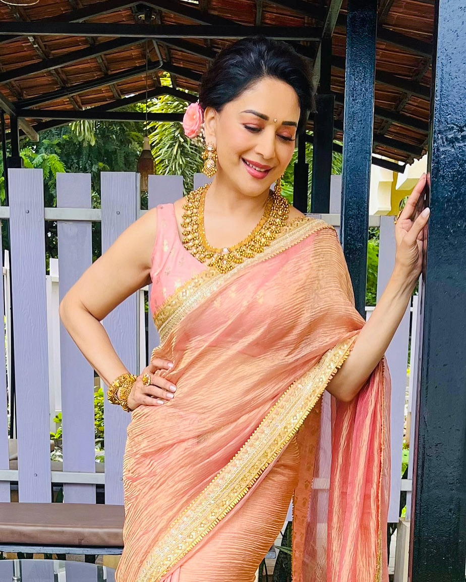 Madhuri Dixit blends tradition with modern elegance.