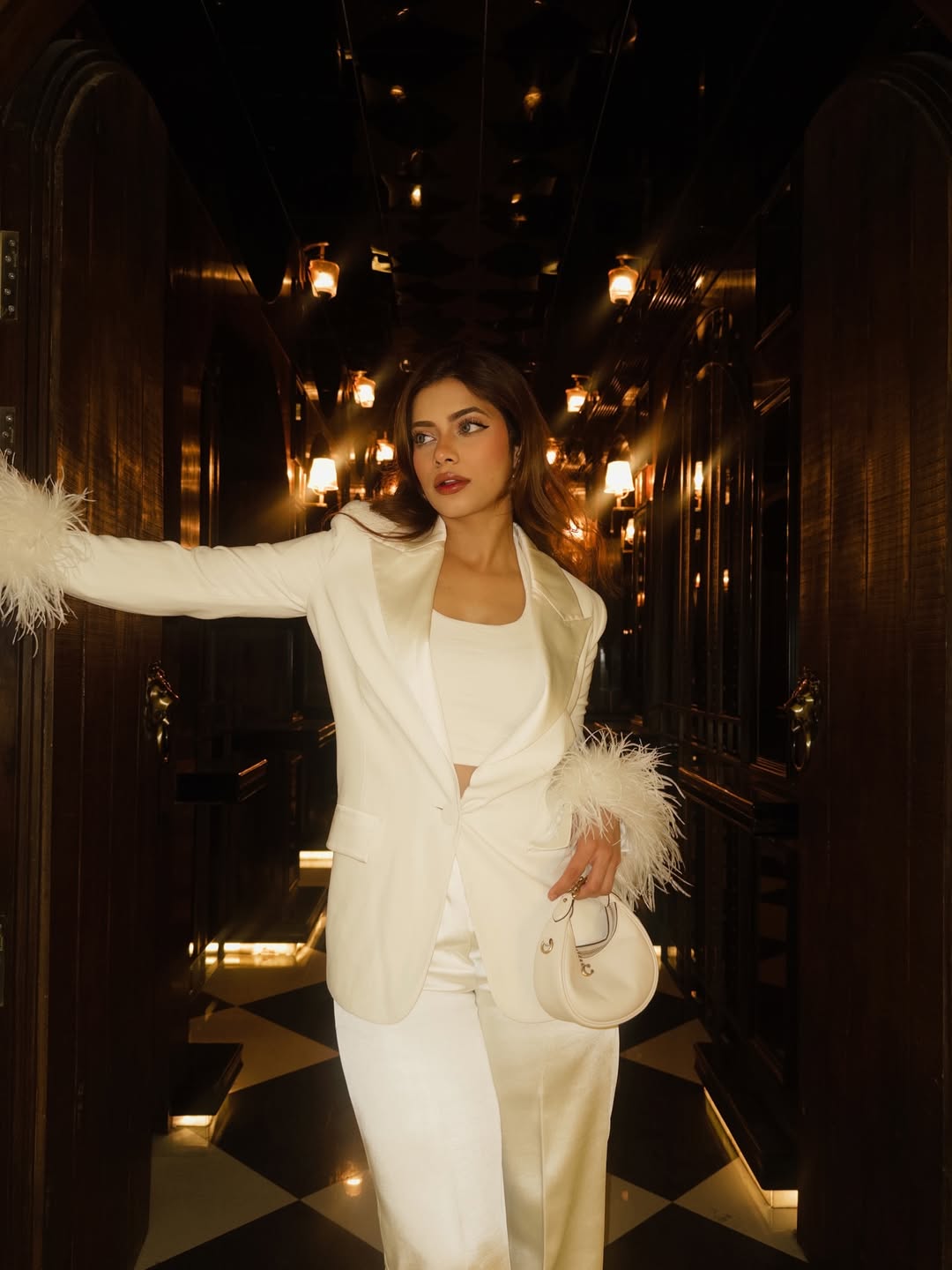 Nagma Mirajkar in all-white ensemble with feathers