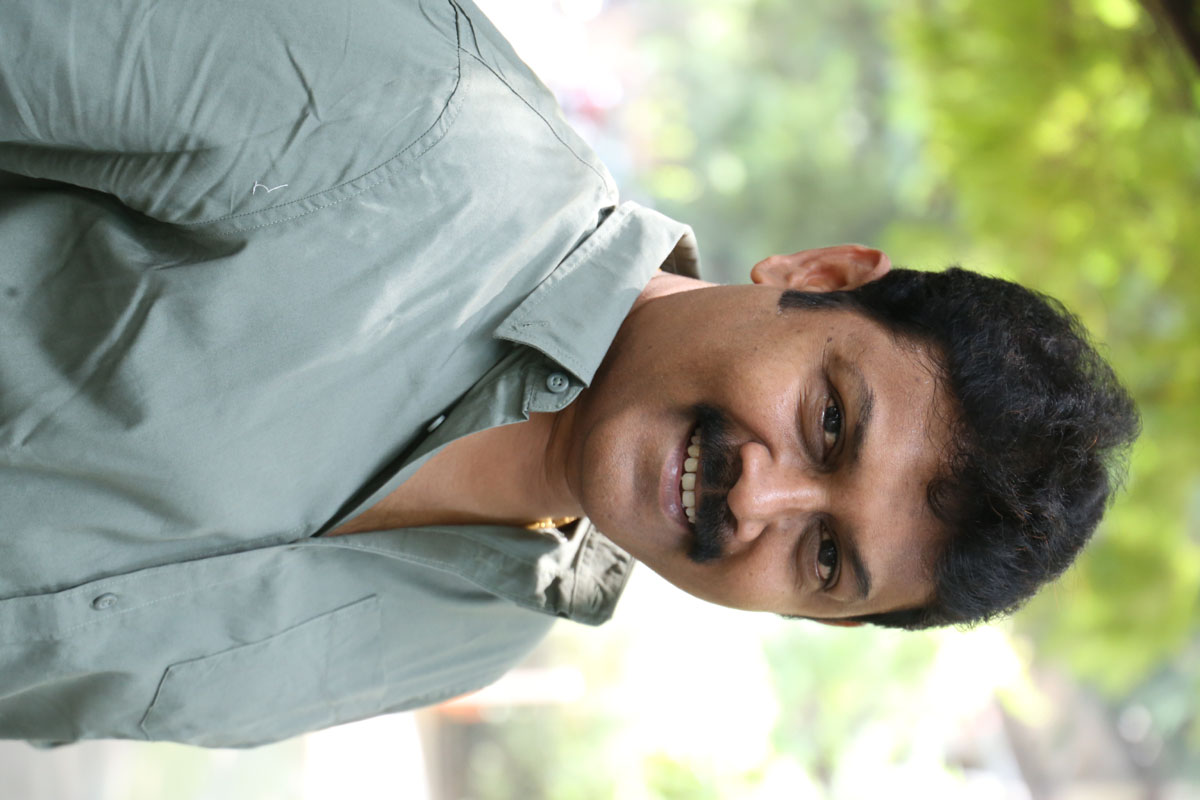 Praveen’s sharp sense of style and confident stance prove that even a simple shirt can make a statement–fashion forward with a touch of mystery!