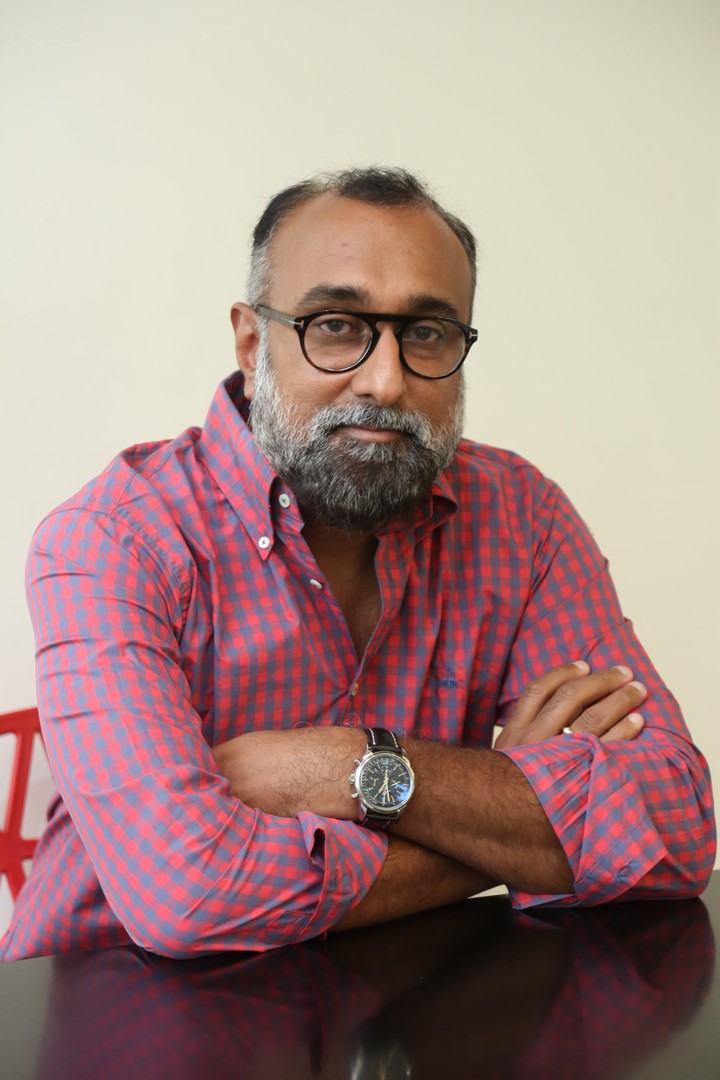Rajeev Reddy Yeduguru confident gaze with checkered shirt