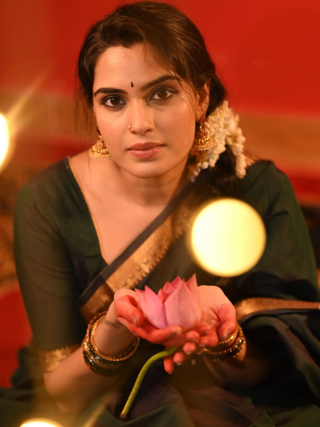 Sangeetha Bhat elegant attire with floral gesture