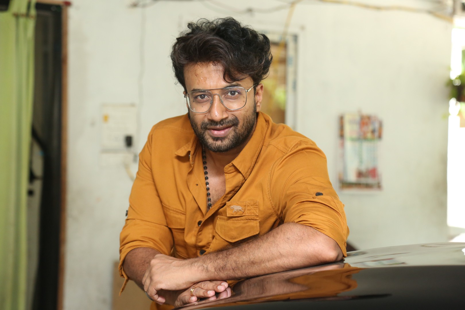 Satyadev effortlessly combines swagger and style in a bold mustard shirt, proving that even a casual look can command attention with a dash of charisma and a splash of humor.