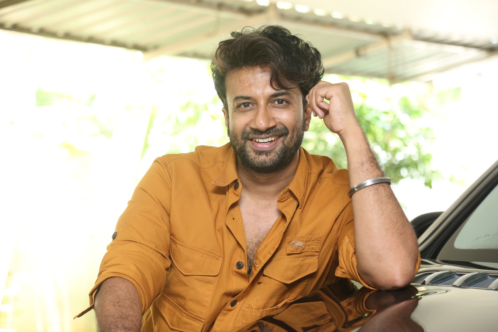 Satyadev exudes effortless charm in a stylish mustard shirt, proving that a confident look and a hint of humor are the best accessories for making any day brighter.