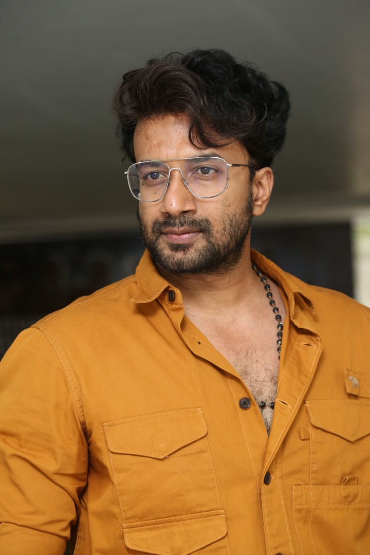 Satyadev’s vibrant mustard shirt and confident style prove that fashion and flair are always in season–blurry face or not!