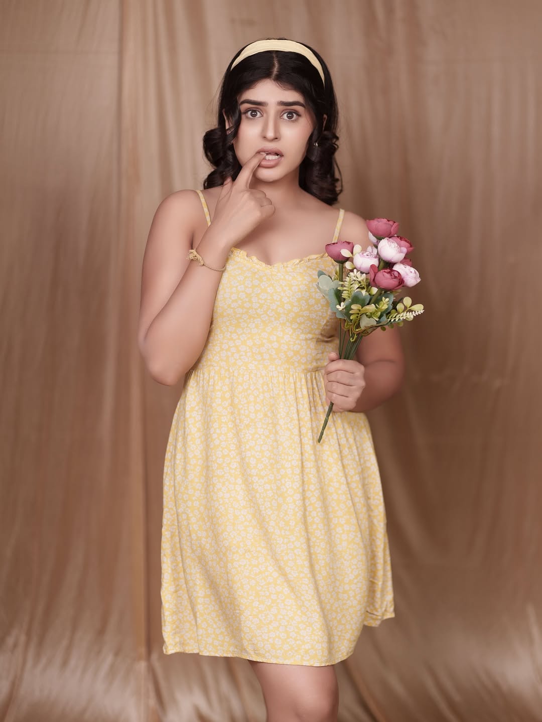 Sharanya Shetty effortlessly combines sunshine and elegance in a yellow floral dress–proof that a good dress and a bouquet can brighten up any room, even if the face is playing hide and seek!