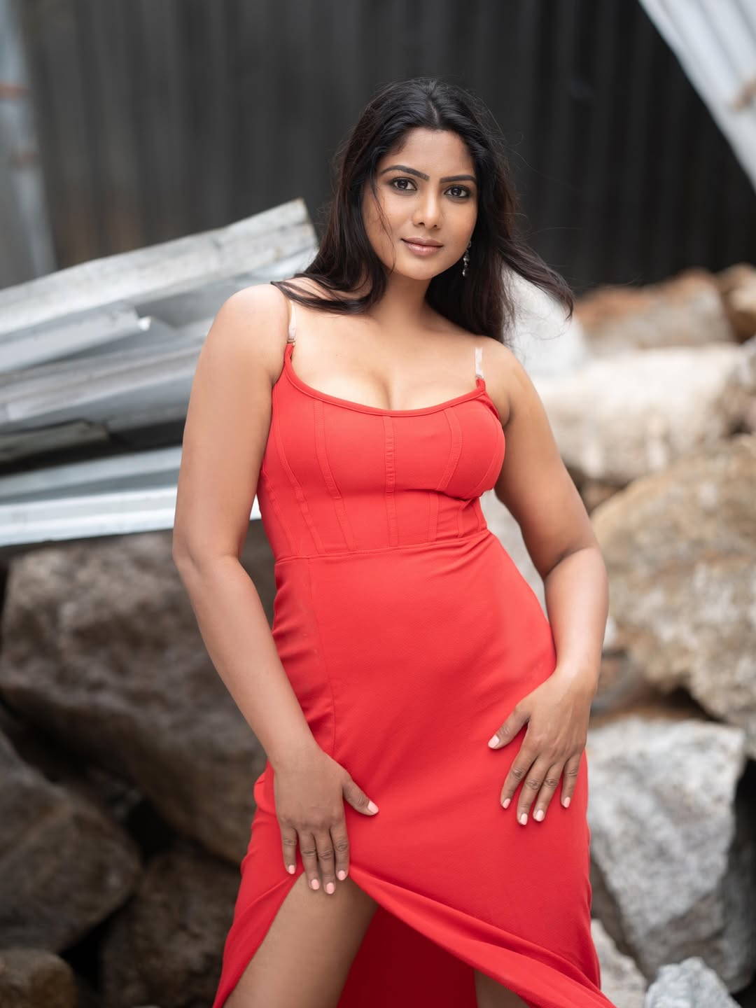 Shruti Reddy in bold red amidst rocky backdrop