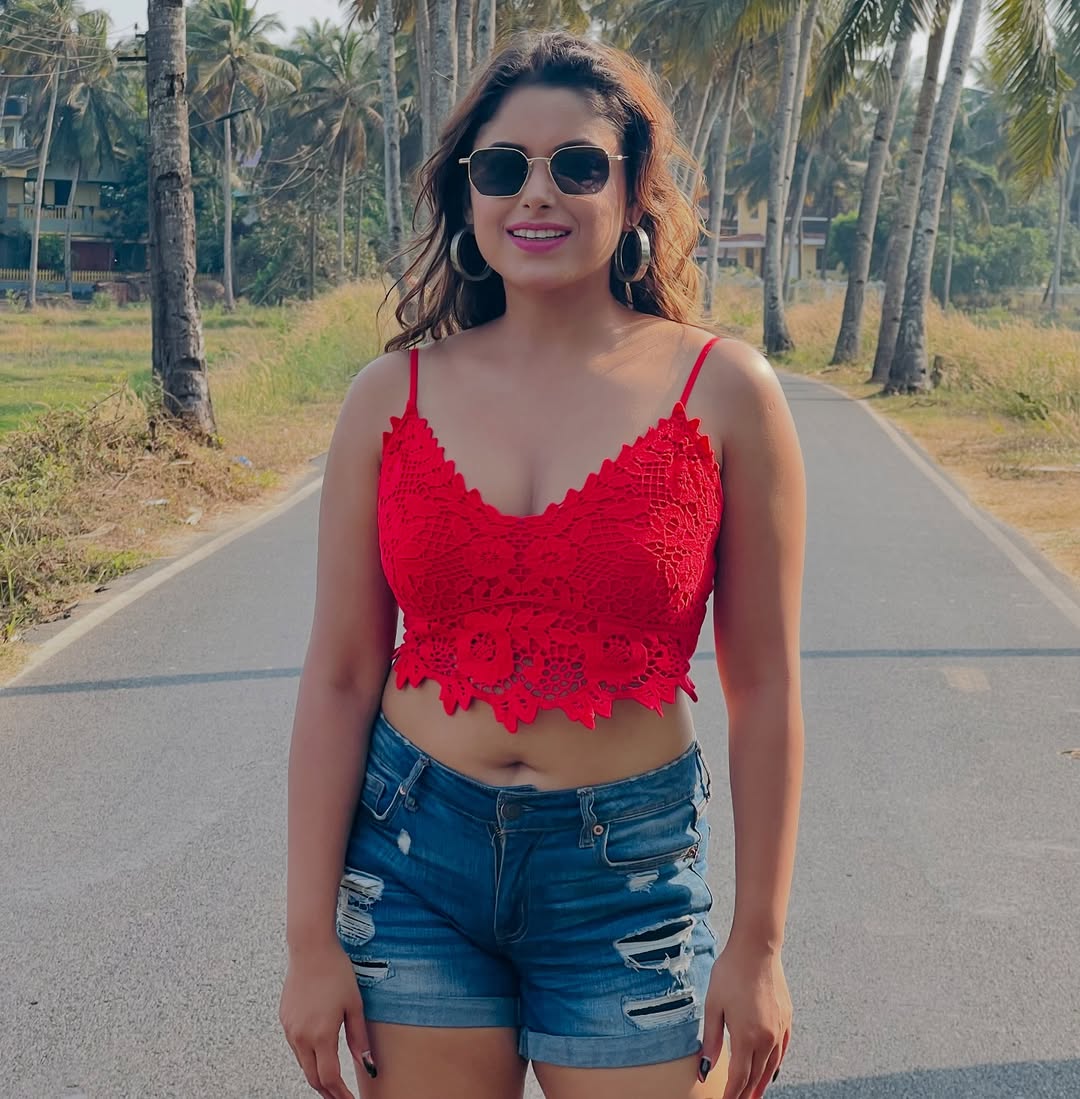 Sneha Paul in red crochet top and denim shorts