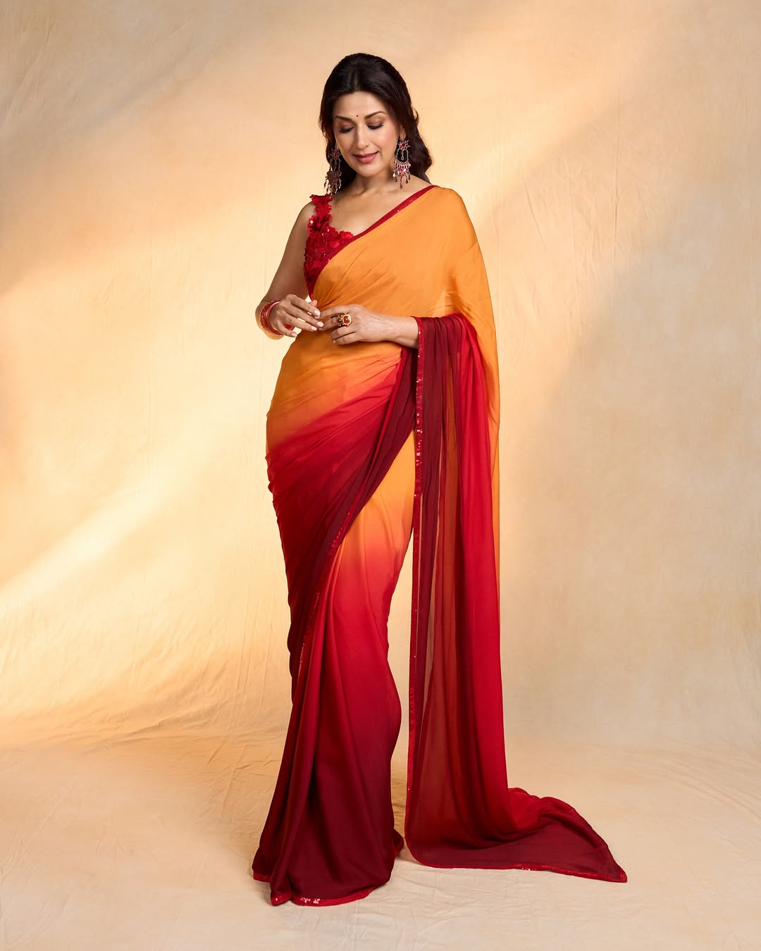 Sonali Bendre’s vibrant saree effortlessly blends tradition with modern flair, proving that style and humor are the perfect accessories–she's truly a masterclass in timeless elegance with a dash of fun!
