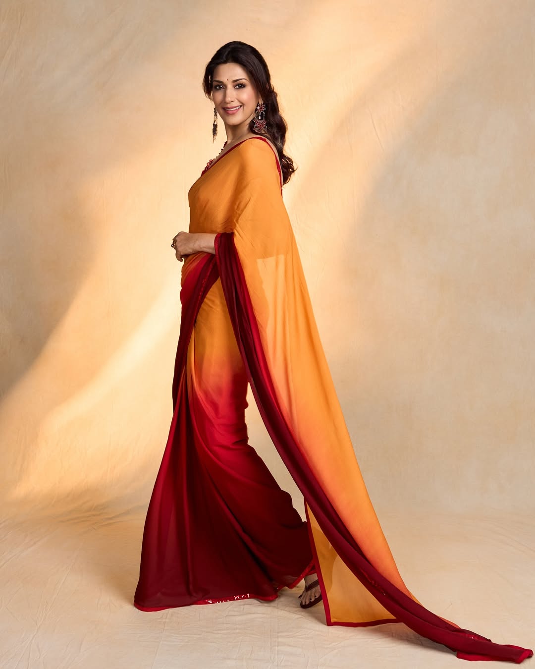 Sonali Bendre embodies timeless elegance with a splash of vibrant color, proving that even in traditional attire, she’s got a contemporary flair–and perhaps a secret to making sarees look like runway magic!