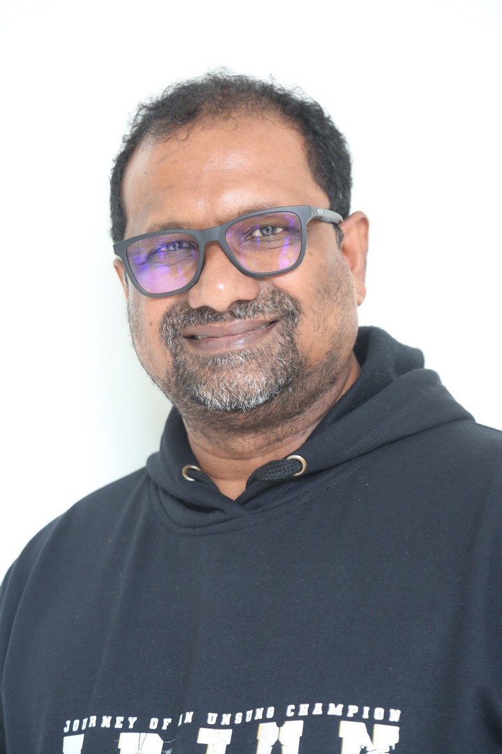 Srini Gubbala sporting sleek black hoodie, street-smart casual vibe