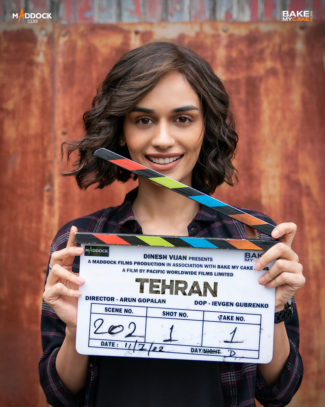 A behind-the-scenes moment captures Manushi Chhillar holding the film’s clapboard, marking the start of a pivotal scene.
