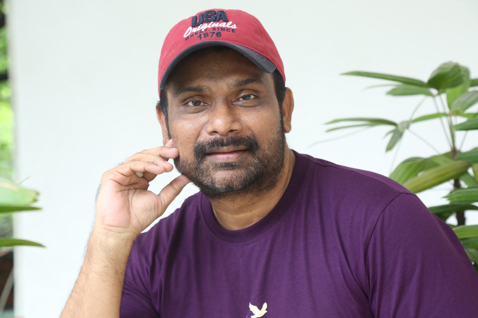 Vijay Donkada in purple tee and red cap