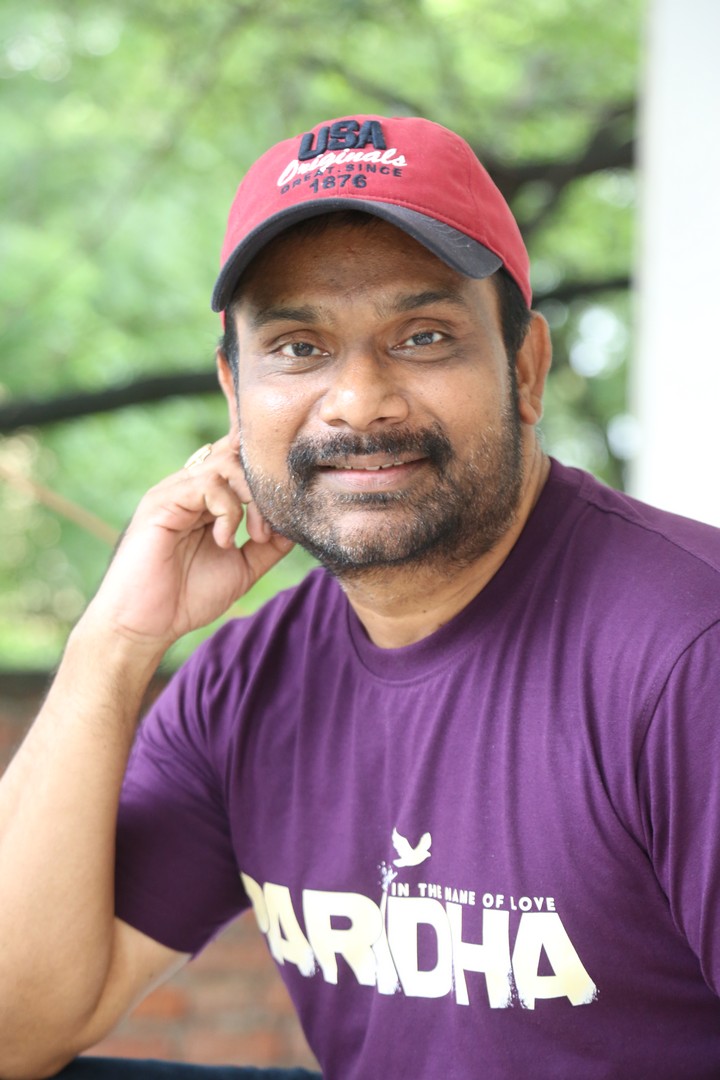 Vijay Donkada casual style in purple tee, cap