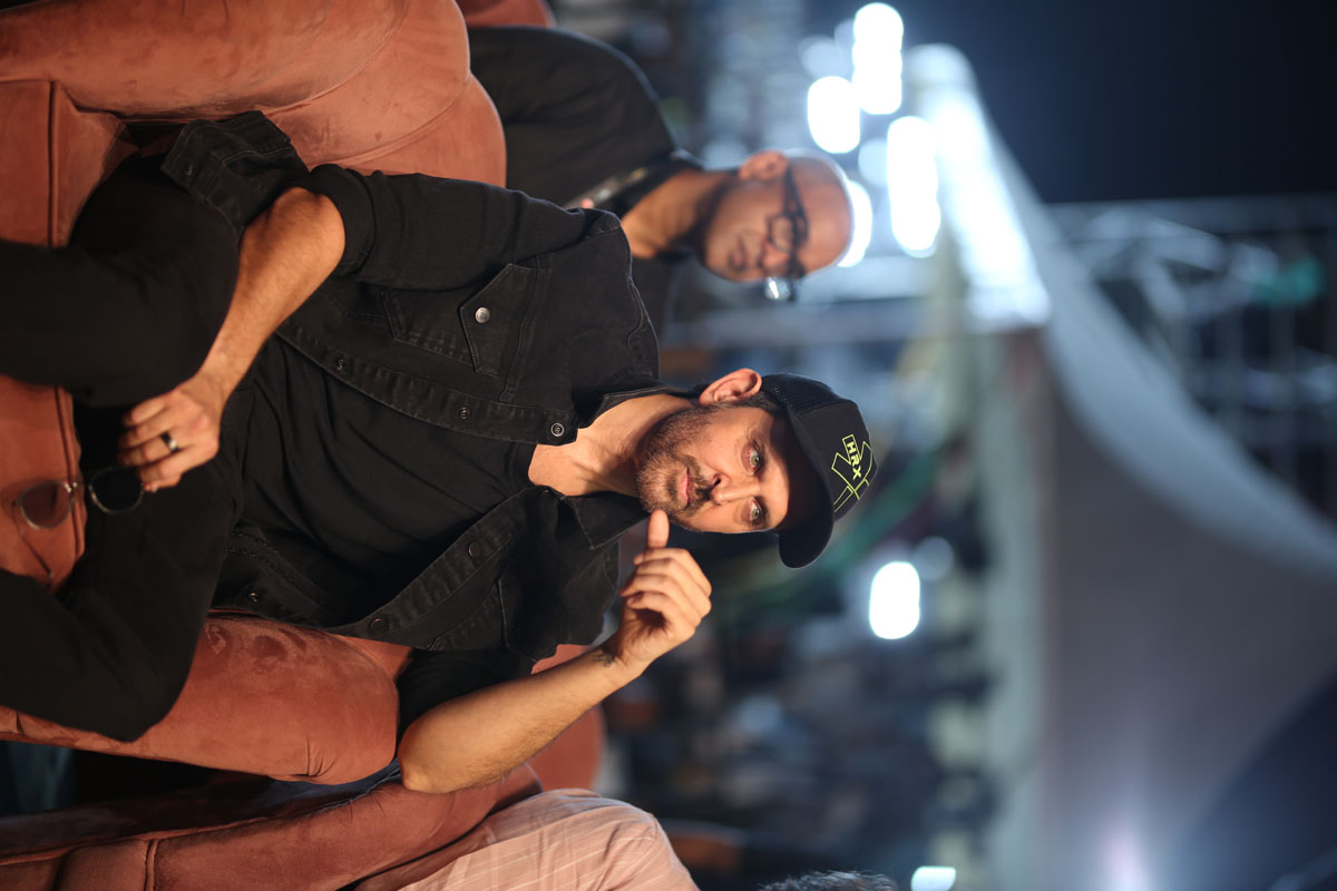 Hrithik Roshan seated with a relaxed poise