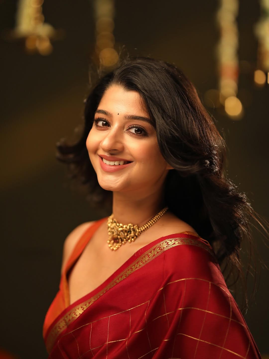 Aishani Shetty regal in red saree with jewelry