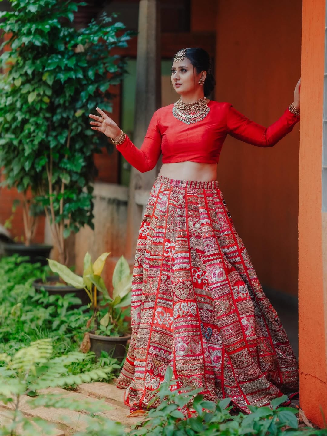 Amulya regal red attire radiating royal celebration vibes