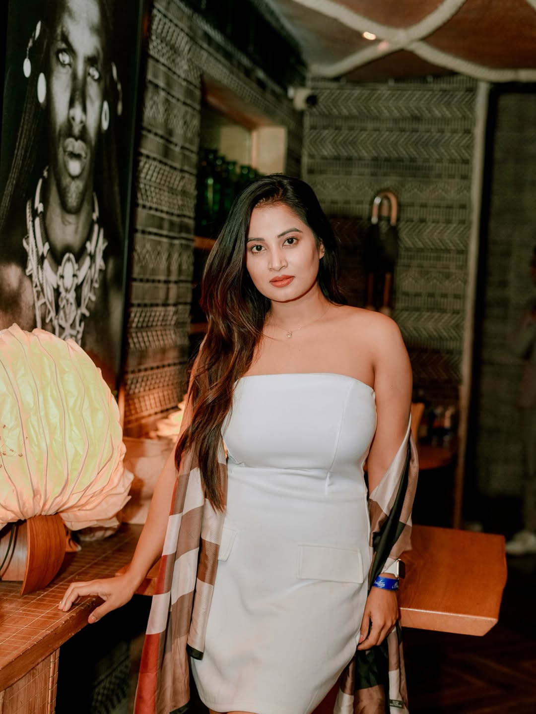 Anusha Rai in chic white dress with flowing hair