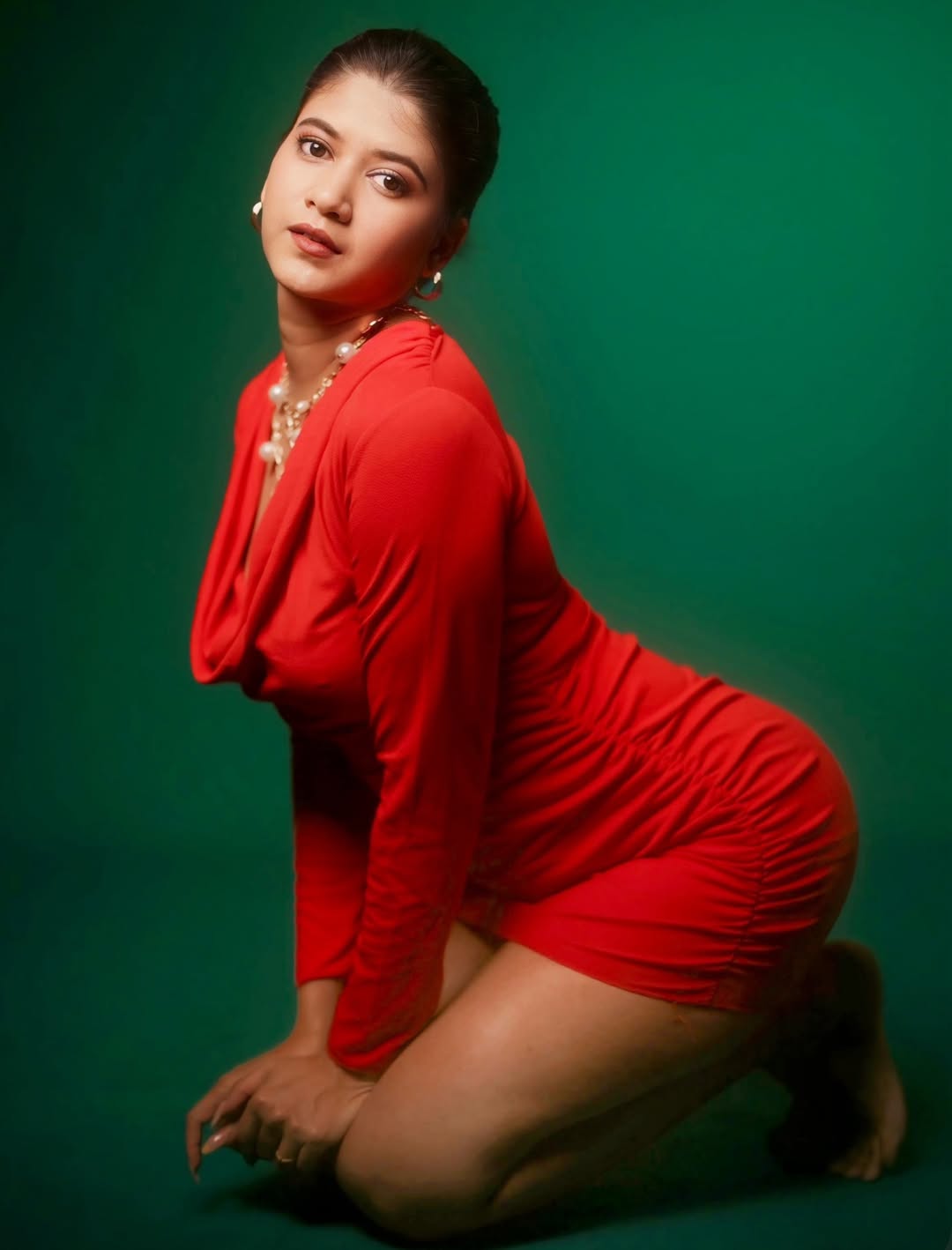 Deepika Gowda in vibrant red attire with timeless grace