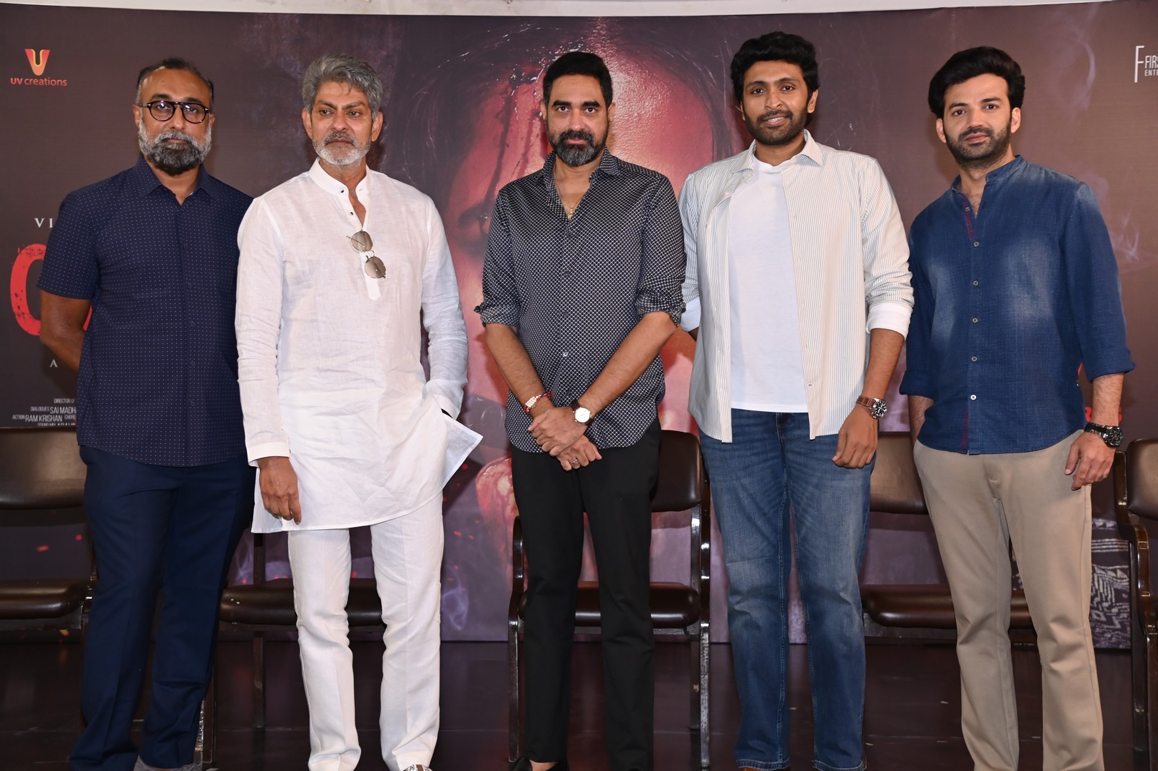 Cast and crew posing together for photoshoot