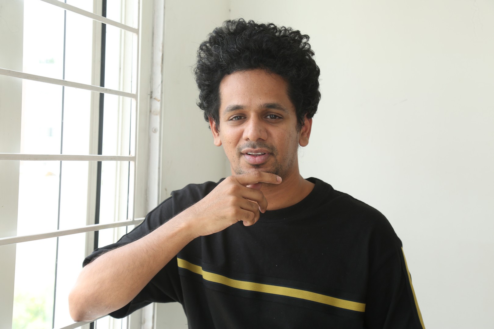 Karthik Gattamneni in casual black tee with curly hair