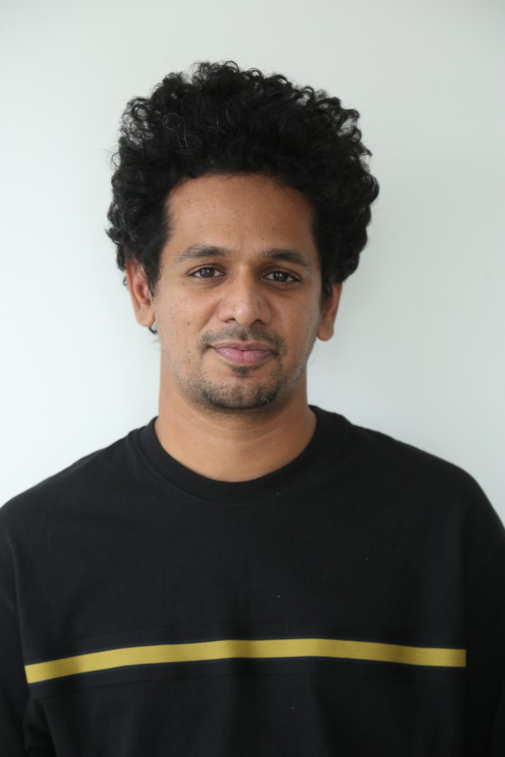 Karthik Gattamneni rocking sleek black attire with curly hair