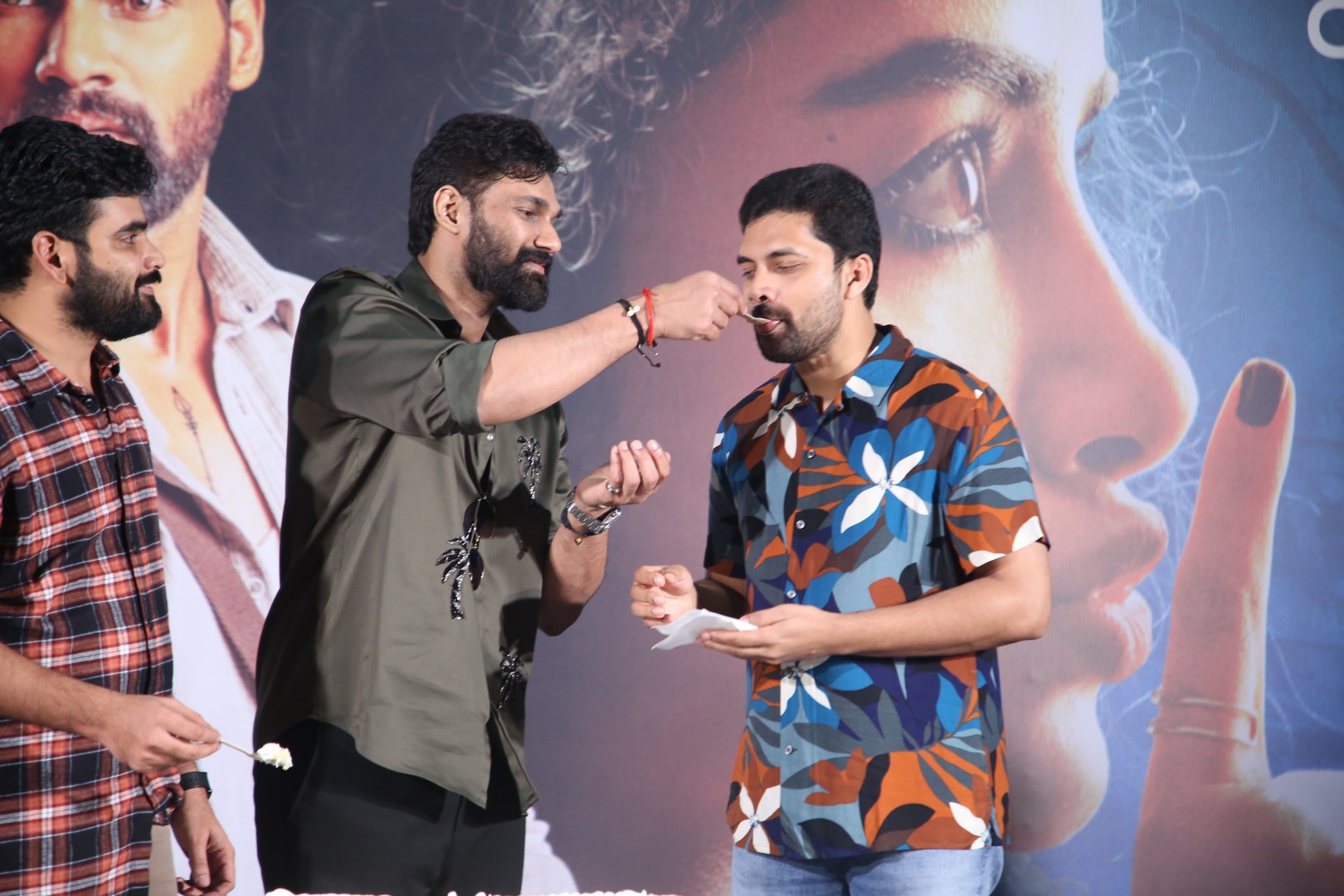 Actor feeding cake to producer