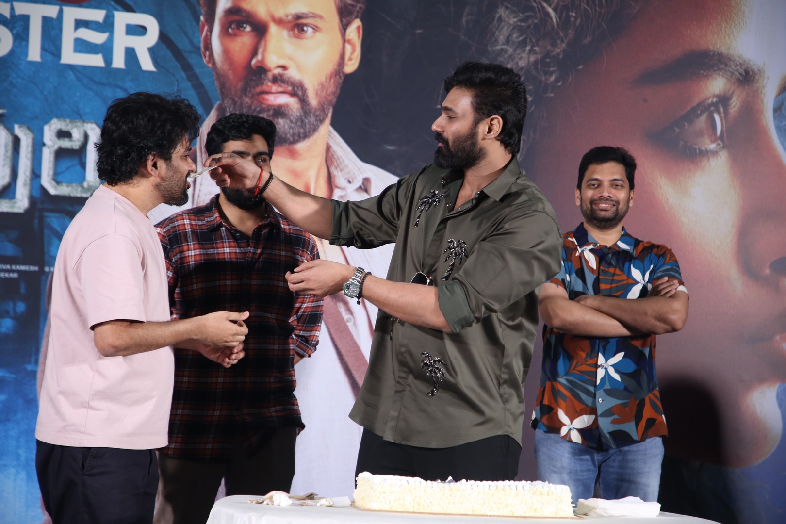 Actor feeding cake to music director