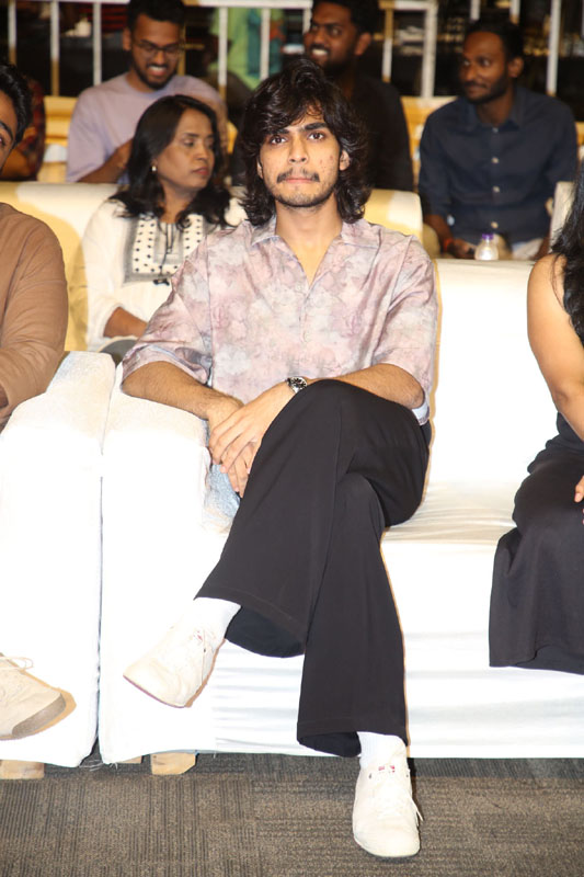 Naslen seated calm and relaxed at event