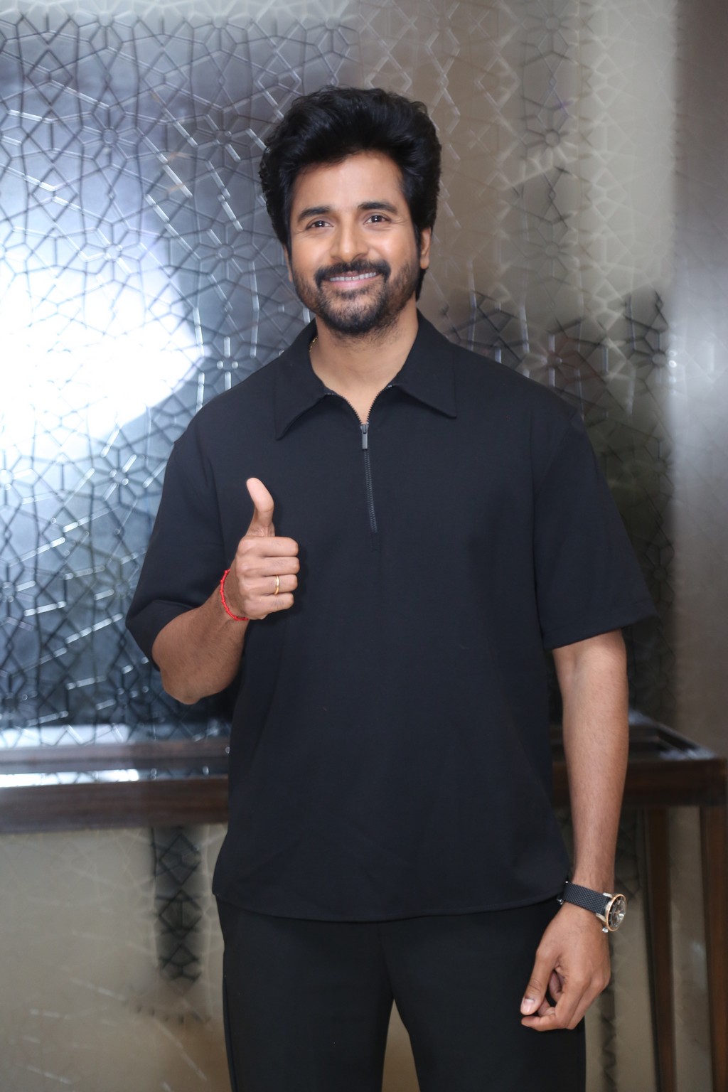 Sivakarthikeyan smiling with thumbs-up pose