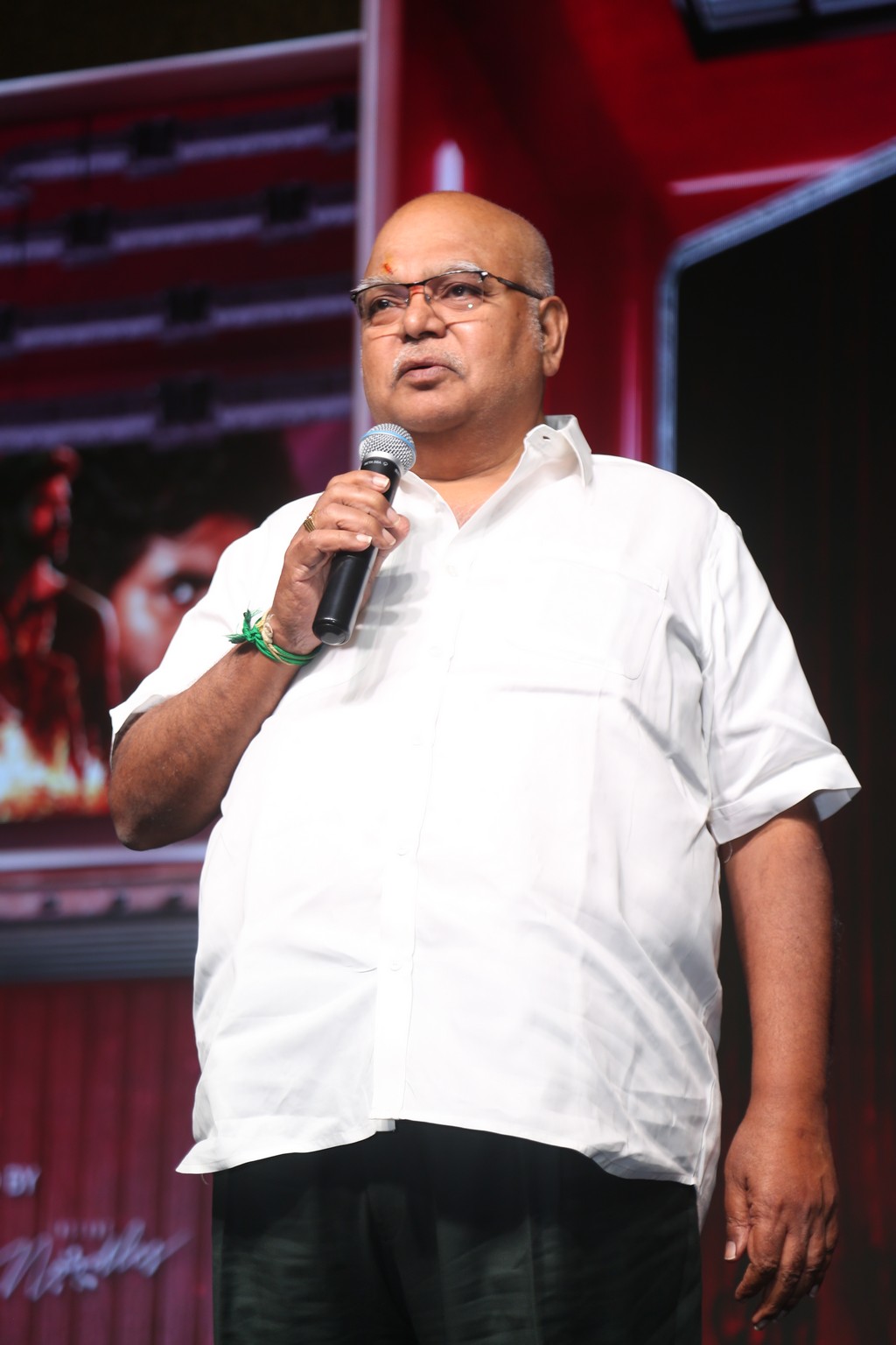 Producer NV Prasad speaking on stage
