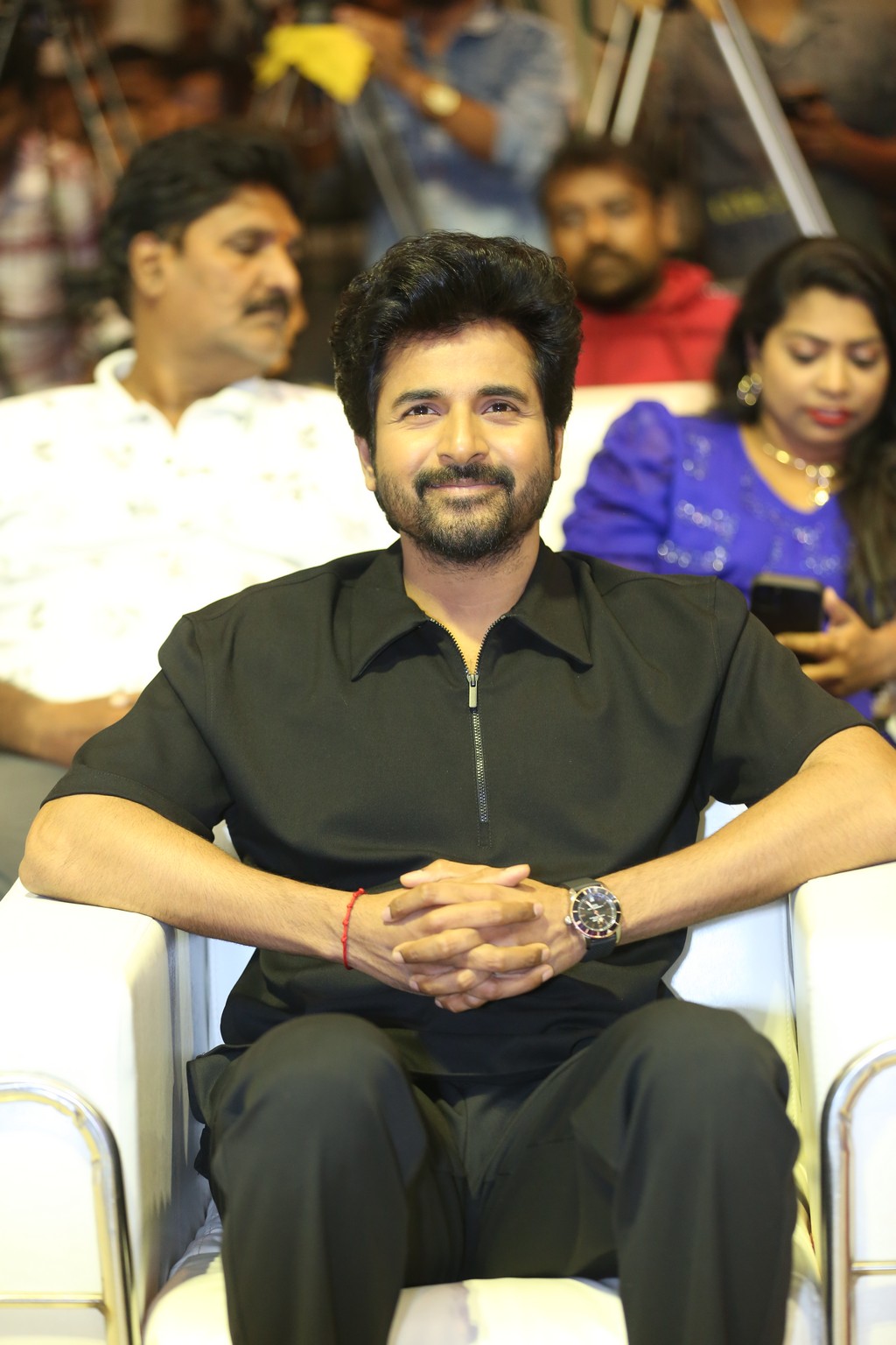 Sivakarthikeyan smiling while seated