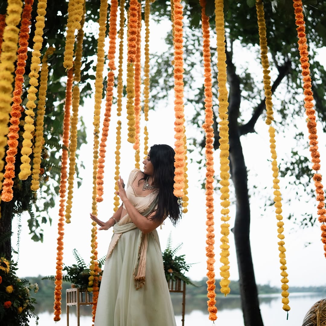 Mirna Menon stands stylish beneath vibrant marigold canopy