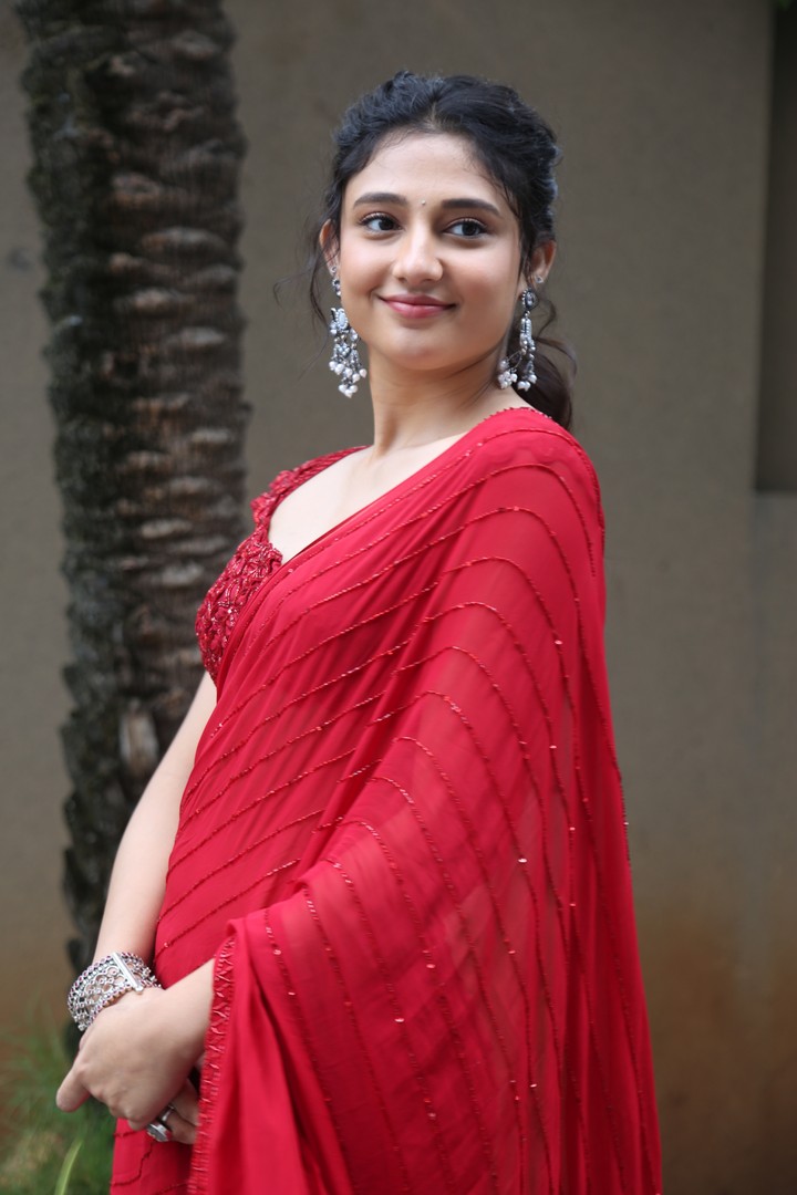 Ritika Nayak in vibrant red saree with modern sparkle