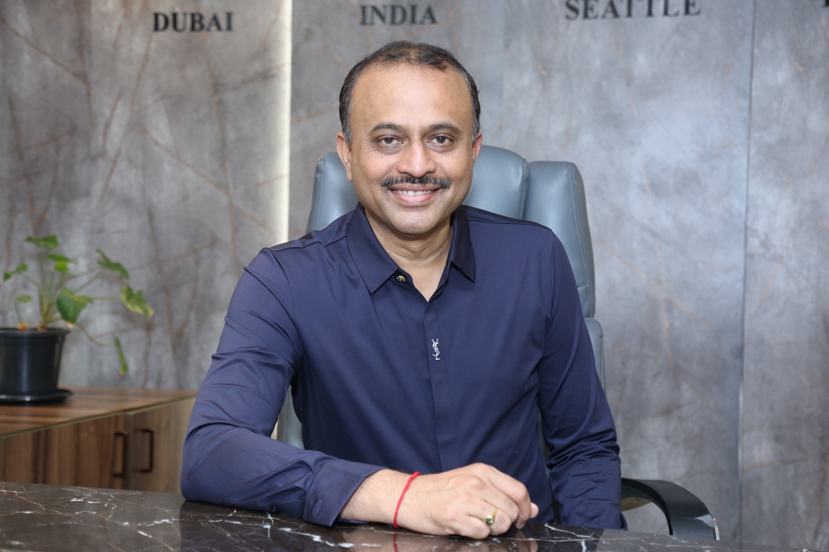 TG Vishwa Prasad polished and professional in navy shirt